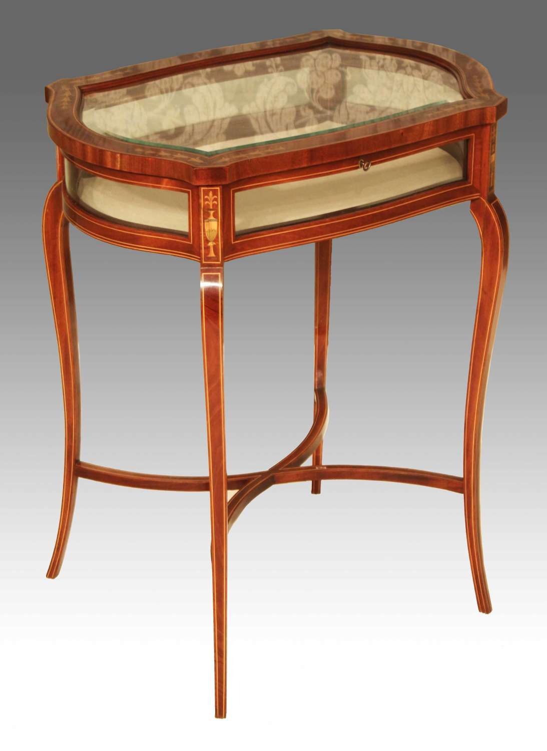 A late Victorian mahogany inlaid serpentine shaped bijouterie table
