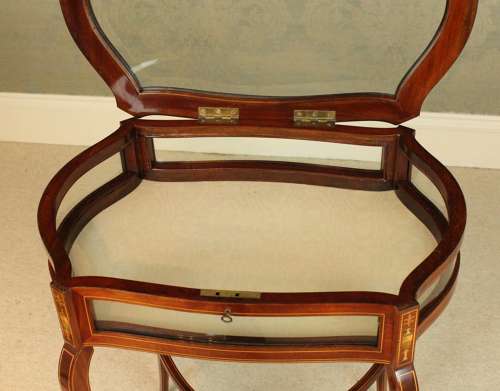 A late Victorian mahogany inlaid serpentine shaped bijouterie table