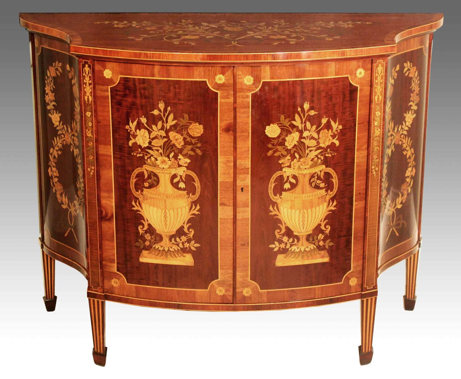 A Superb Late Victorian Mahogany Inlaid Serpentine Commode